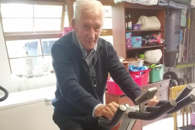 Jim Copeland, 95, on the exercise bike in his garage