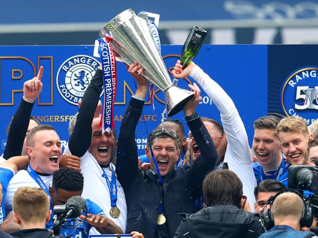 Rangers manager Steven Gerrard and his assistant Gary McAllister celebrate with the trophy after winning the Scottish Premiership at Ibrox Stadium, Glasgow.