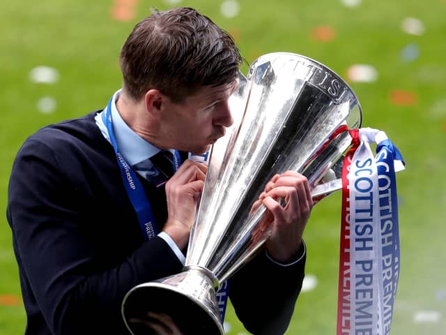 Rangers manager Steven Gerrard kisses the trophy as he celebrates winning the Scottish Premiership at Ibrox Stadium, Glasgow in May.