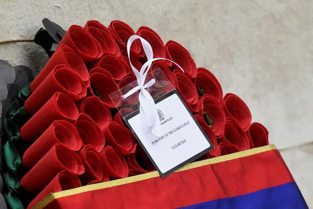 Message from Queen Elizabeth II is seen in detail on a wreath laid on her behalf by the Duke of Cambridge during the Remembrance Sunday service at the Cenotaph, in Whitehall, London. Picture date: Sunday November 14, 2021.