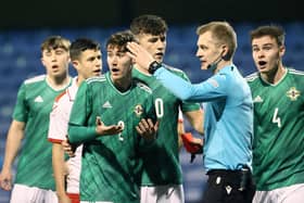 Northern Ireland's Trai Hume remonstrates with the referee after he is shown a straight red card
