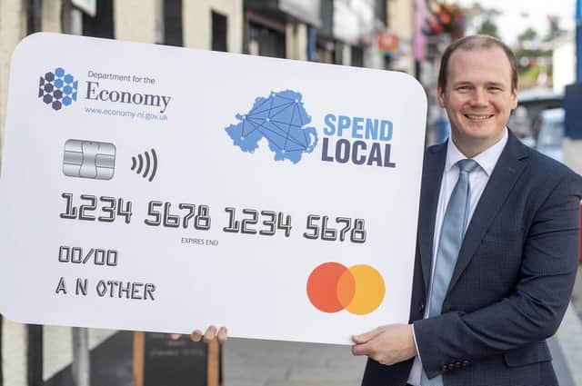 Economy Minister Gordon Lyons with a larger than life Spend Local card