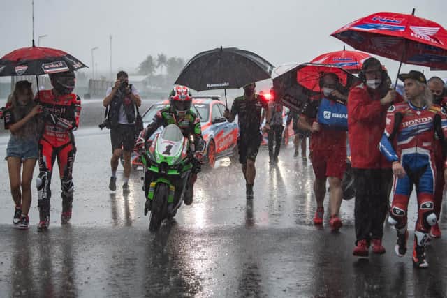 Jonathan Rea makes his way back to the Kawasaki pit-box after rain lashed the Mandalika International Street Circuit ahead of Race 1 on Saturday.