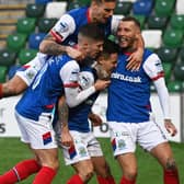 Jordan Stewart (centre) is mobbed by team-mates following his decisive goal for Linfield in victory over Cliftonville. Pic by Pacemaker