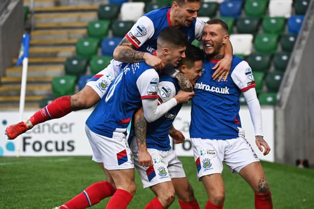 Jordan Stewart (centre) is mobbed by team-mates following his decisive goal for Linfield in victory over Cliftonville. Pic by Pacemaker