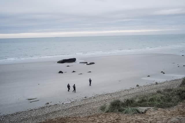 French police patrol the beach in search of migrants in Wimereux, northern France, above, last week