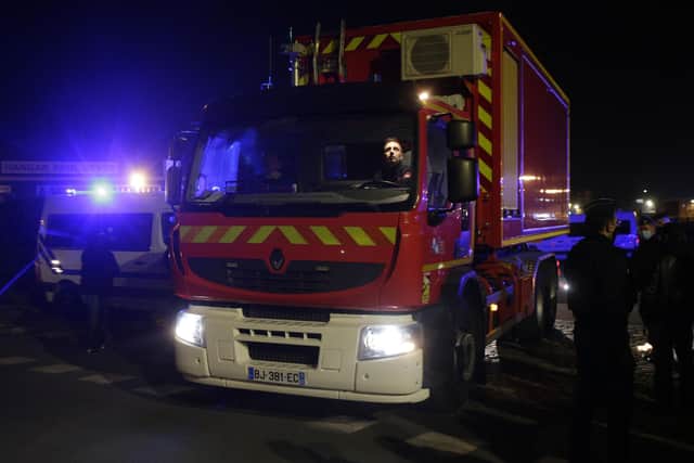 A rescue worker truck leaves the port of Calais, northern France, Wednesday, Nov. 24, 2021 (AP Photo/Michel Spingler)