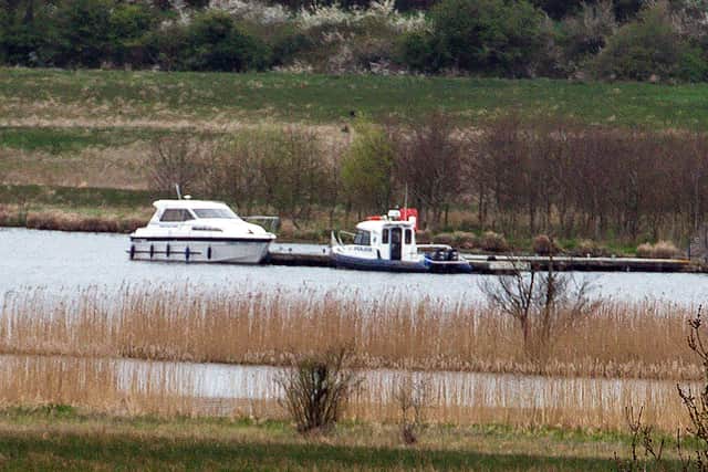 The boat from which Lu Na was murdered, seen in 2017 moored at the rear of Devenish Island along with a police boat