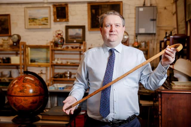 Auctioneer Karl Bennett holding a walking stick belonging to Nazi propagandist Lord Haw Haw. The stick is expected to sell for between £4,000 and £7,000 when it goes under the hammer at Bloomfield auction house in east Belfast on Tuesday