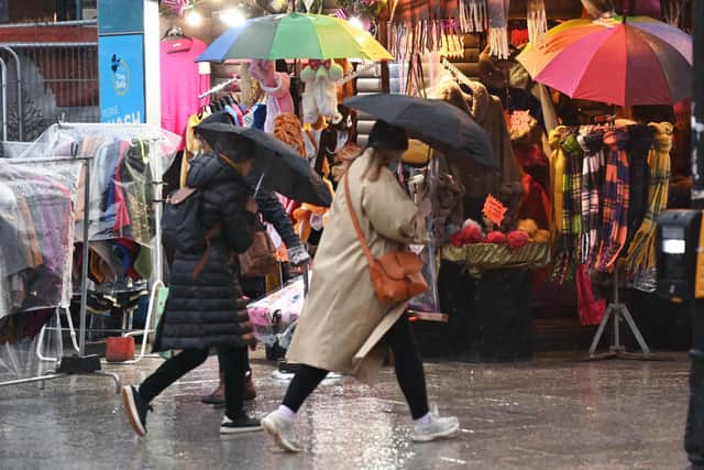 Battling through the stormy weather at Belfast Christmas Market. 
Pic Colm Lenaghan/ Pacemaker