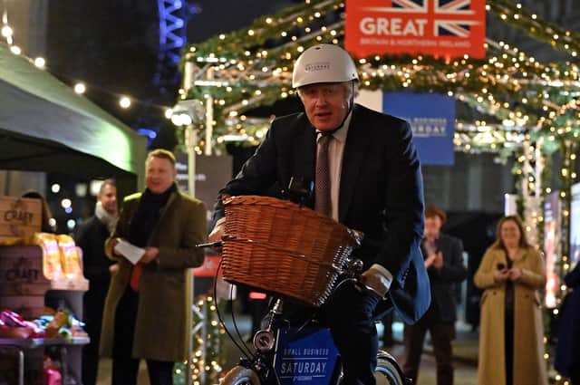 Prime Minister Boris Johnson riding a bicycle as he visits a UK Food and Drinks market which has been set up in Downing Street, London.