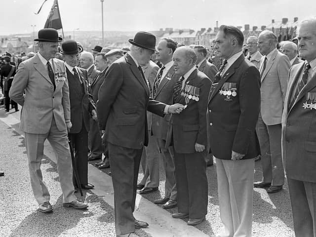 Lord Grey admires a Dunkirk medal worn by Mr Cecil McAlister from Portrush during the official opening ceremony of the new Bennet House in Portrush in September 1981. Mr Alister served in France, Italy, North Africa, Egypt, Syria and Palestine. Vice Admiral Sir Arthur Hezlet, area president of the Royal British Legion is included on the left of the photograph. Picture: News Letter archives