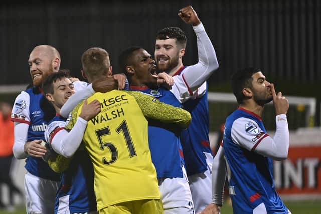 Linfield players celebrate with keeper David Walsh after their penalty shootout victory over Cliftonville.