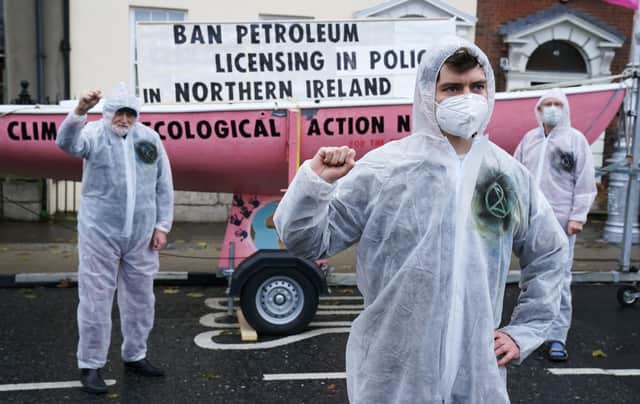 Extinction Rebellion activists Oscar Mooney (centre), from Sandymount, Art O’Laoghaire (left), from Bray, and Louis Heath from Sandyford, as they held a demonstration outside Sinn Fein’s headquarters in Dublin calling on the party to act now in the Northern Irish Executive to ensure a full and final ban on petroleum licensing. Picture date: Wednesday December 8, 2021.