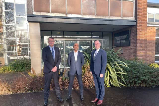 Wrightbus MD, Neil Collins, Wrightbus CEO, Buta Atwal, and First Minister Paul Givan outside the Wrightbus factory in Ballymena