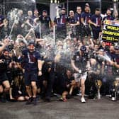 Race winner and 2021 F1 World Drivers Champion Max Verstappen of Netherlands and Red Bull Racing celebrates with his team after the F1 Grand Prix of Abu Dhabi
