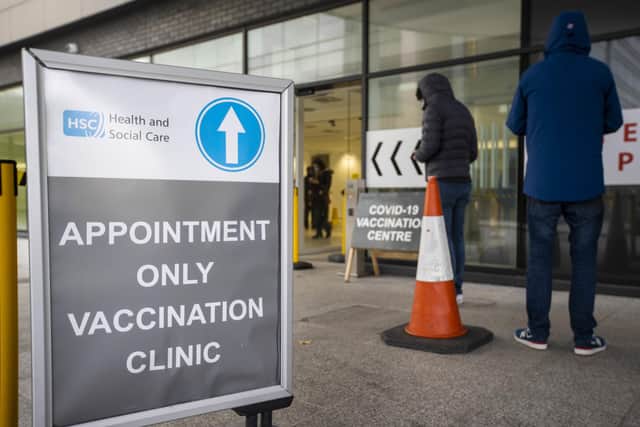 People queuing at the COVID-19 vaccination centre at Dundonald Hospital in Belfast, Northern Ireland. PA Photo. Picture date: Tuesday December 14 2021. See PA story ULSTER Coronavirus. Photo credit should read: Liam McBurney/PA Wire