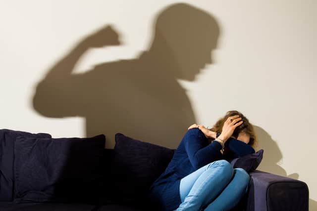 PICTURE POSED BY MODEL File photo dated 09/03/15 of a shadow of a man with a clenched fist as a woman cowers in the corner.