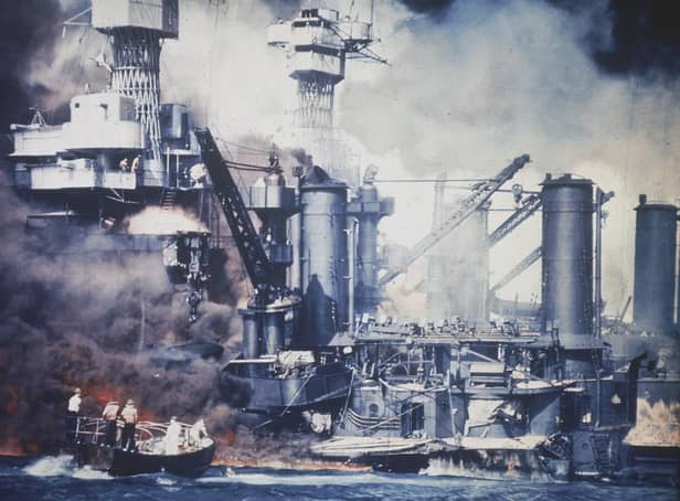 Photograph showing a small boat rescuing a USS West Virginia crew member from the water after the Japanese bombing of Pearl Harbor, Hawaii on December 7, 1941. Picture: US Navy via AP