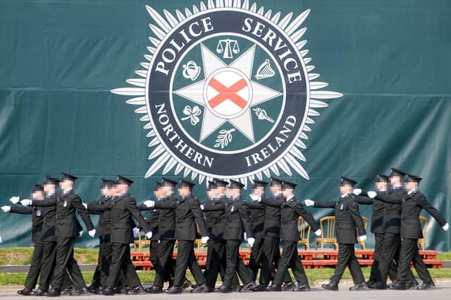 Police recruits march past a PSNI sign during a graduation ceremony. Photo: Stephen Davison/Pacemaker
