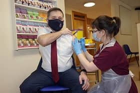 Health Minister Robin Swann receiving his booster covid jab from Victoria Robinson, specialist pharmacist at his local GP practice in Kells.