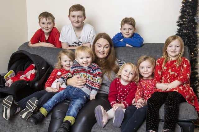 Jennifer Johnston with nine of her fourteen children, seven week old Freya, Jaxon, 22 months, Ebony, three, Heidi, four, Sofia, six, Lydia, eight, Alfie, nine, Joell, 12, and Kaleb, 14 at their home in Newry, in Co Down. Jennifer Johnston, 42, has recently given birth to her 14th child and she told PA news agency about the festive fun of trying to cook Christmas dinner for one of the biggest families in the UK. Picture date: Monday December 13, 2021.