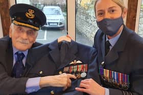 Group Captain John ‘Paddy’ Hemingway receives his fresh uniform and restored medals from Wing Commander Jacqueline Rankin