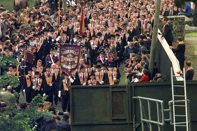 Members of the Orange Order from the Portadown District marching from Drumcree Church towards the barricade blocking their route along the nationalist Garvaghy Road. PA image