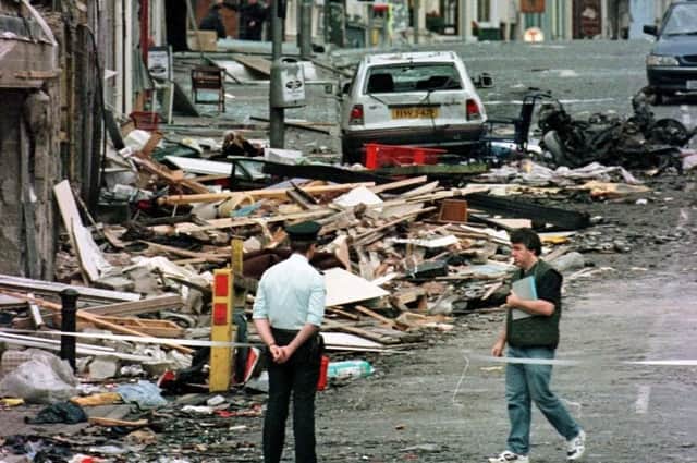 A police officer looking at the damage caused by a bomb explosion in Market Street, Omagh in 1998