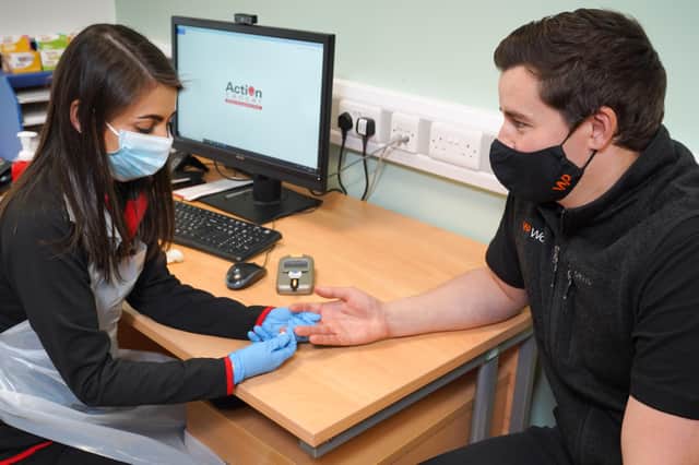 Action Cancer’s Health Promotion Officer Tanya Carson provides WorkPal Sales Director Ian Megahey with a MOT health check as part of the charity’s men’s health campaign