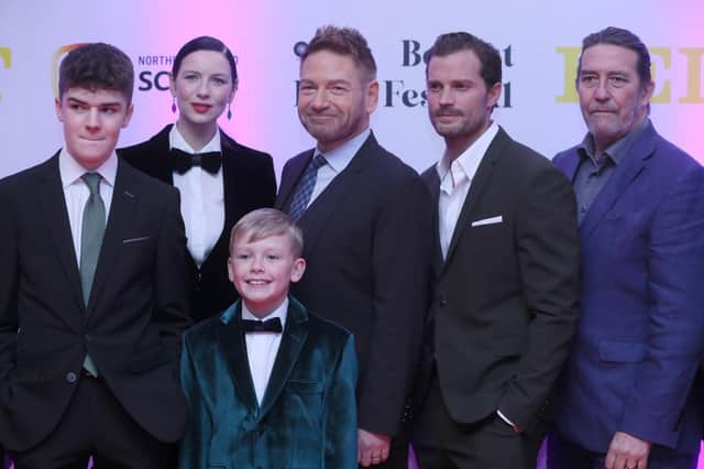 Lewis McAskie, Caitriona Balfe, Kenneth Branagh, Jamie Dornan and Ciaran Hinds with Jude Hill in front as they attend the Irish premiere of film Belfast at the Waterfront Hall, Belfast, to mark the opening night of the Belfast Film Festival