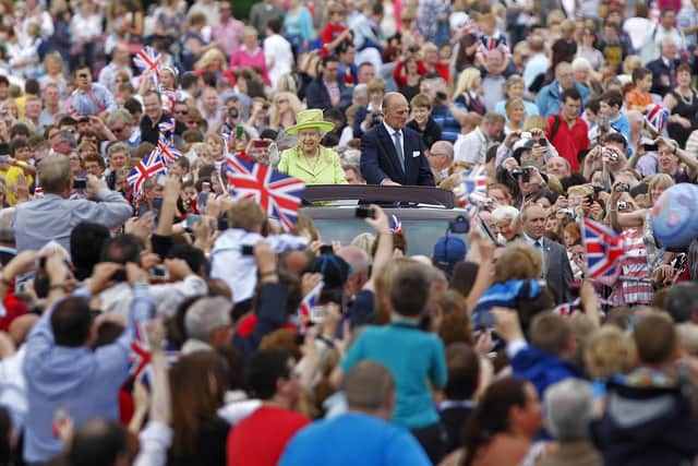 Queen Elizabeth II and the Duke of Edinburgh tour the grounds of Stormont in Belfast in 2012, during a two-day visit to Northern Ireland as part of the Diamond Jubilee tour of the UK. Photo: Julien Behal/PA Wire
