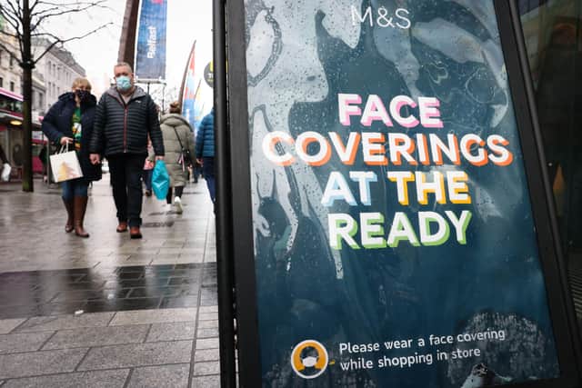 A sign in Belfast city centre reminding customers to wear face coverings