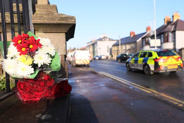 Flowers left at the scene of a fatal stabbing on Church Street in Downpatrick, Co Down