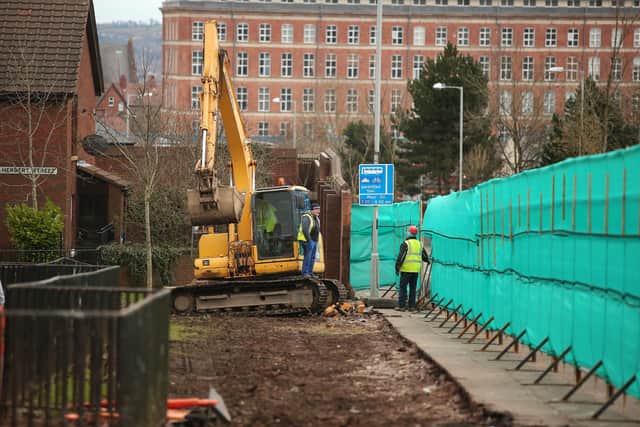 Workmen dismantle part of a peace wall on the Crumlin Road in Belfast in 2016