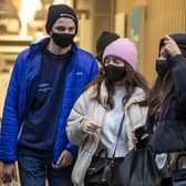 Christmas shoppers wearing face masks leave Primark in Belfast city centre.