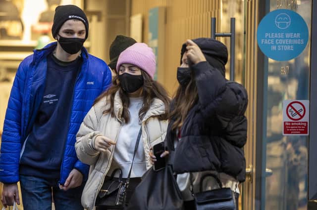 Christmas shoppers wearing face masks leave Primark in Belfast city centre.