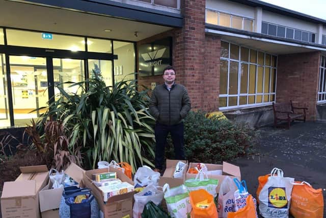 Andrew Kelly with the collection of food bank donations