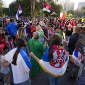 Supporters of Serbia's Novak Djokovic yesterday dance and sing outside the Park Hotel, used as an immigration detention hotel where Djokovic is confined in Melbourne, Australia, (AP Photo/Mark Baker)
