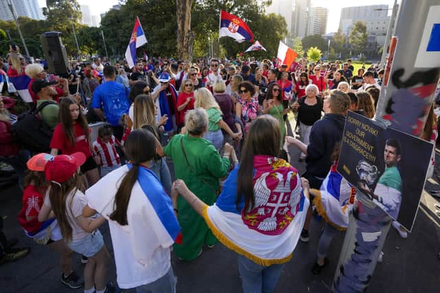 Supporters of Serbia's Novak Djokovic yesterday dance and sing outside the Park Hotel, used as an immigration detention hotel where Djokovic is confined in Melbourne, Australia, (AP Photo/Mark Baker)