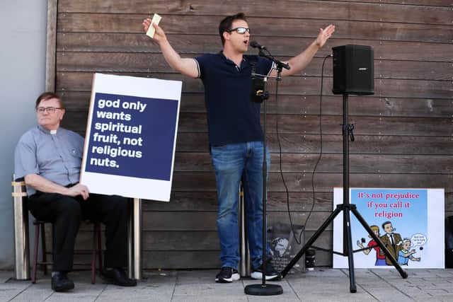 Independent Catholic Priest Pat Buckley (pictured with blue and white sign) holds a protest in Larne against street preacher Ryan Williamson and colleagues. 

Picture by Jonathan Porter/PressEye