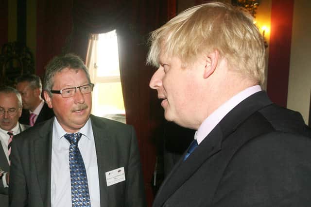 Sammy Wilson advises Boris Johnson about the gathering at 10 Downing Street — or maybe it isn’t Boris, maybe it is the lookalike in a wig