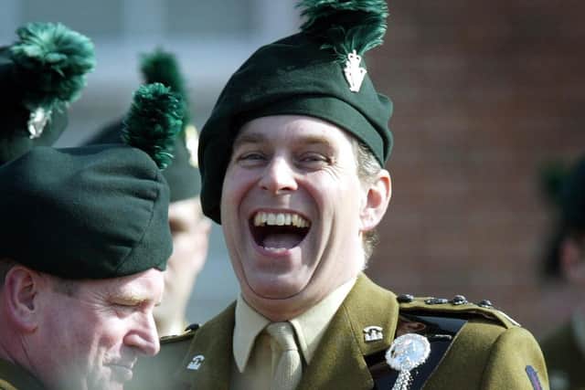 The Duke of York, who is Colonel in Chief of the Royal Irish Regiment, jokes with new recruits to the regiment, at a passing out parade at the Regiment's Headquarters in Ballymena, Northern Ireland on St Patrick's Day in 2003. Photo: Paul Faith/PA Wire