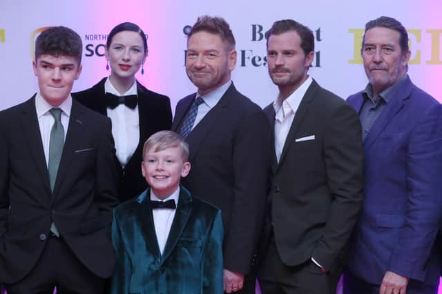 Lewis McAskie, Caitriona Balfe, Kenneth Branagh, Jamie Dornan and Ciaran Hinds with Jude Hill in front as they attend the Irish premiere of film Belfast at the Waterfront Hall, Belfast