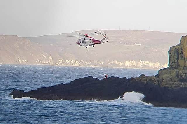 A Coastguard helicopter assists with an operation over Ballintoy