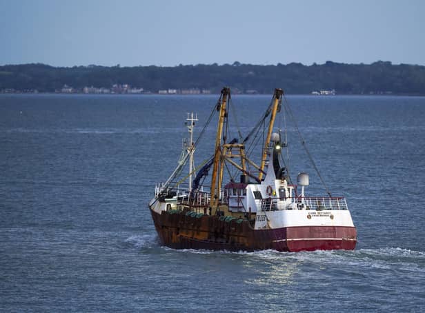 A fishing trawler leaving harbour.