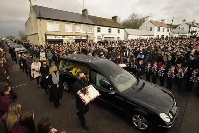 Mourners walk beside the hearse as the cortege arrives at St Brigid's Church, Mountbolus, Co Offaly, for the funeral of Ashling Murphy. PA image