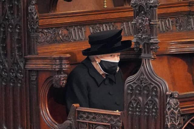 Queen Elizabeth II after taking her seat for the funeral of her husband, the Duke of Edinburgh, in St George's Chapel, Windsor Castle in April.
