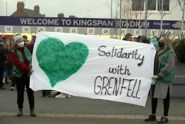 People protest outside the Kingspan Stadium in Belfast ahead of the match with Clermont Auvergne on Saturday. Protestors have demonstrated outside the home of Ulster Rugby to demand that the club sever ties with main sponsor Kingspan in light of the Grenfell Tower disaster. Picture date: Saturday January 22, 2022. PA Photo. Kingspan products were used in Grenfell tower block in London, where 72 people were killed in a fire in 2017. The Irish insulation firm is Ulster Rugbyâ€TMs shirt sponsor and also holds naming rights to their home stadium in Ravenhill in south Belfast.
A small number of people belonging to a group called Community Action Tenants Union (CATU) gathered at the Kingspan Stadium on Saturday afternoon ahead of Ulsterâ€TMs European Champions Cup clash with Clermont Auvergne. See PA story ULSTER Kingspan . Photo credit should read: Niall Carson/PA Wire
