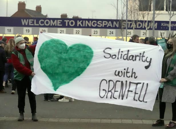 People protest outside the Kingspan Stadium in Belfast ahead of the match with Clermont Auvergne on Saturday. Protestors have demonstrated outside the home of Ulster Rugby to demand that the club sever ties with main sponsor Kingspan in light of the Grenfell Tower disaster. Picture date: Saturday January 22, 2022. PA Photo. Kingspan products were used in Grenfell tower block in London, where 72 people were killed in a fire in 2017. The Irish insulation firm is Ulster Rugbyâ€TMs shirt sponsor and also holds naming rights to their home stadium in Ravenhill in south Belfast.A small number of people belonging to a group called Community Action Tenants Union (CATU) gathered at the Kingspan Stadium on Saturday afternoon ahead of Ulsterâ€TMs European Champions Cup clash with Clermont Auvergne. See PA story ULSTER Kingspan . Photo credit should read: Niall Carson/PA Wire